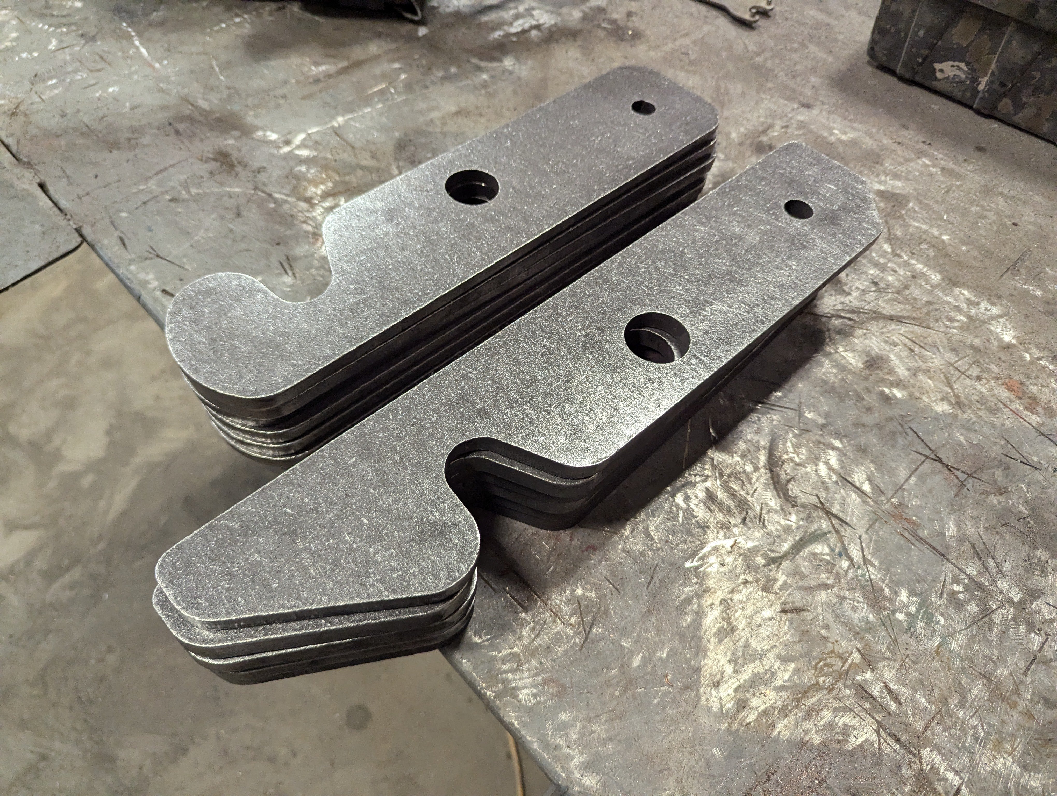 Two styles of dumpster latches