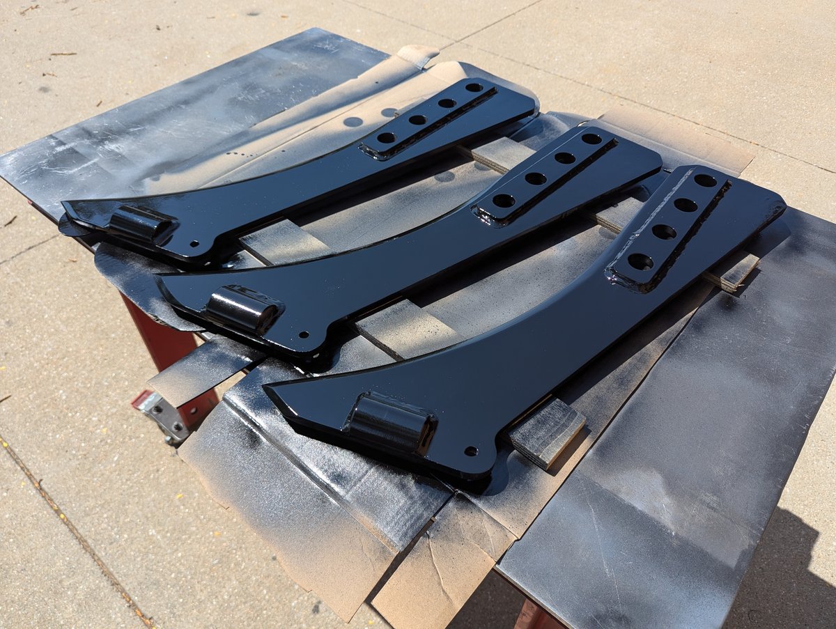 Painting three Case IH Dirt vibratory plow blades in gloss black.