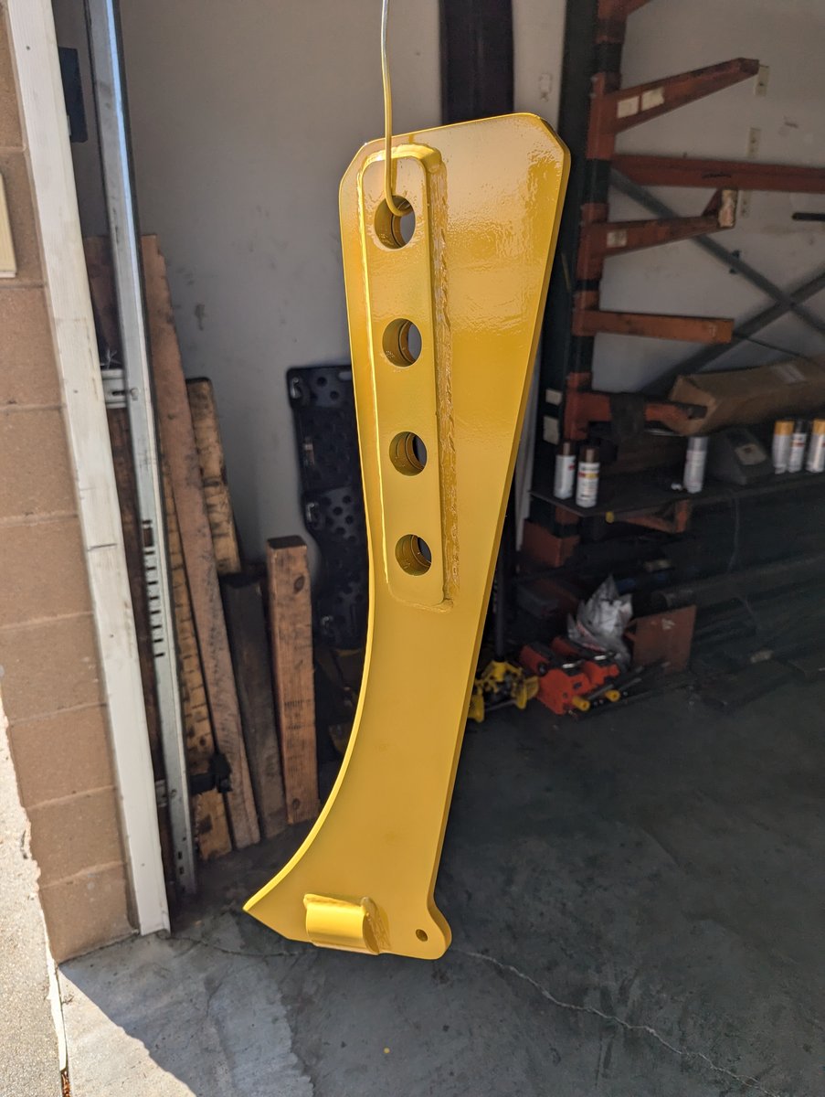 Another vantage point of one Case IH Dirt vibratory plow blade painted yellow.